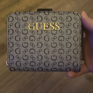 Small simple guess wallet with zipper pouch on side